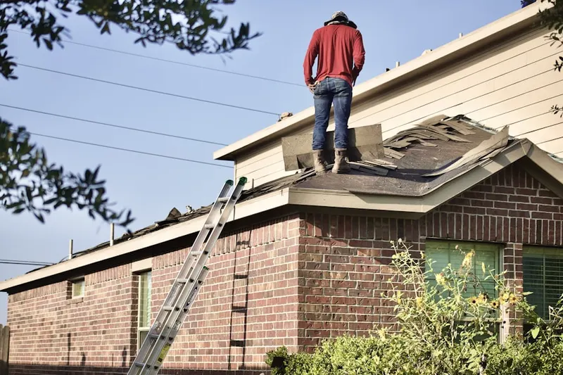 Professional roofer working on a residential roof in Peaceful Valley